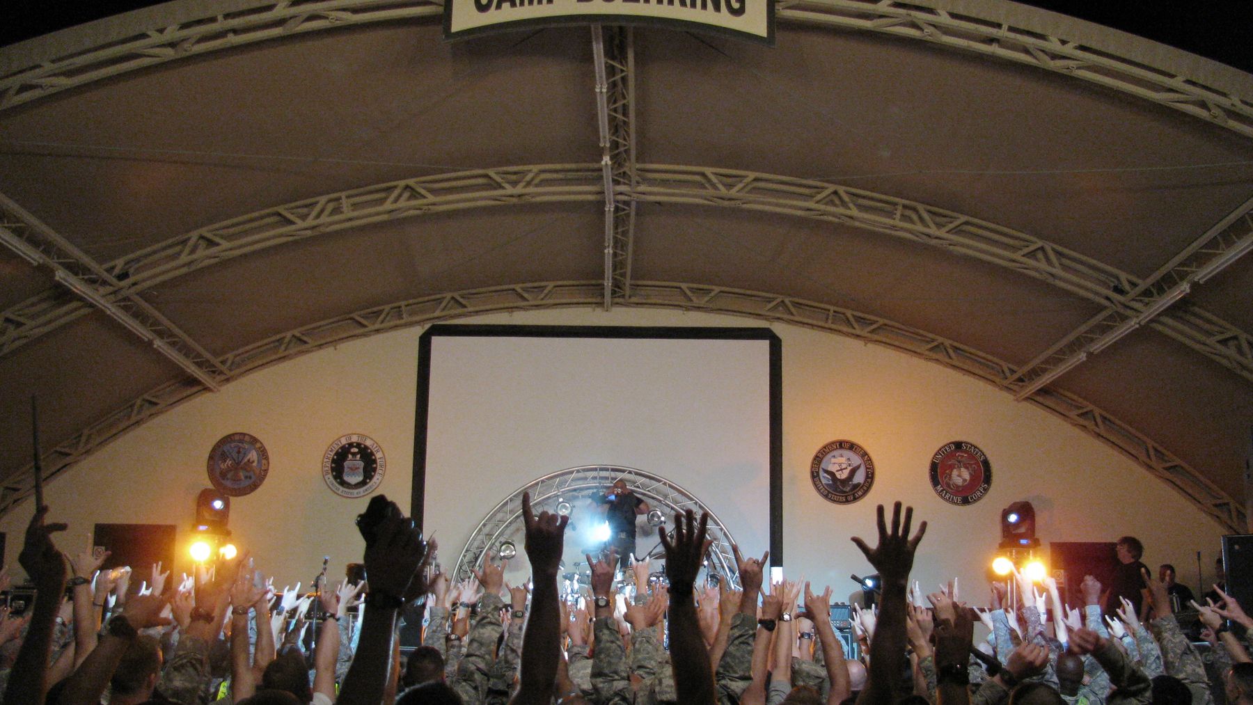 A crowd of service members cheering at a concert at Camp Buehring, Kuwait