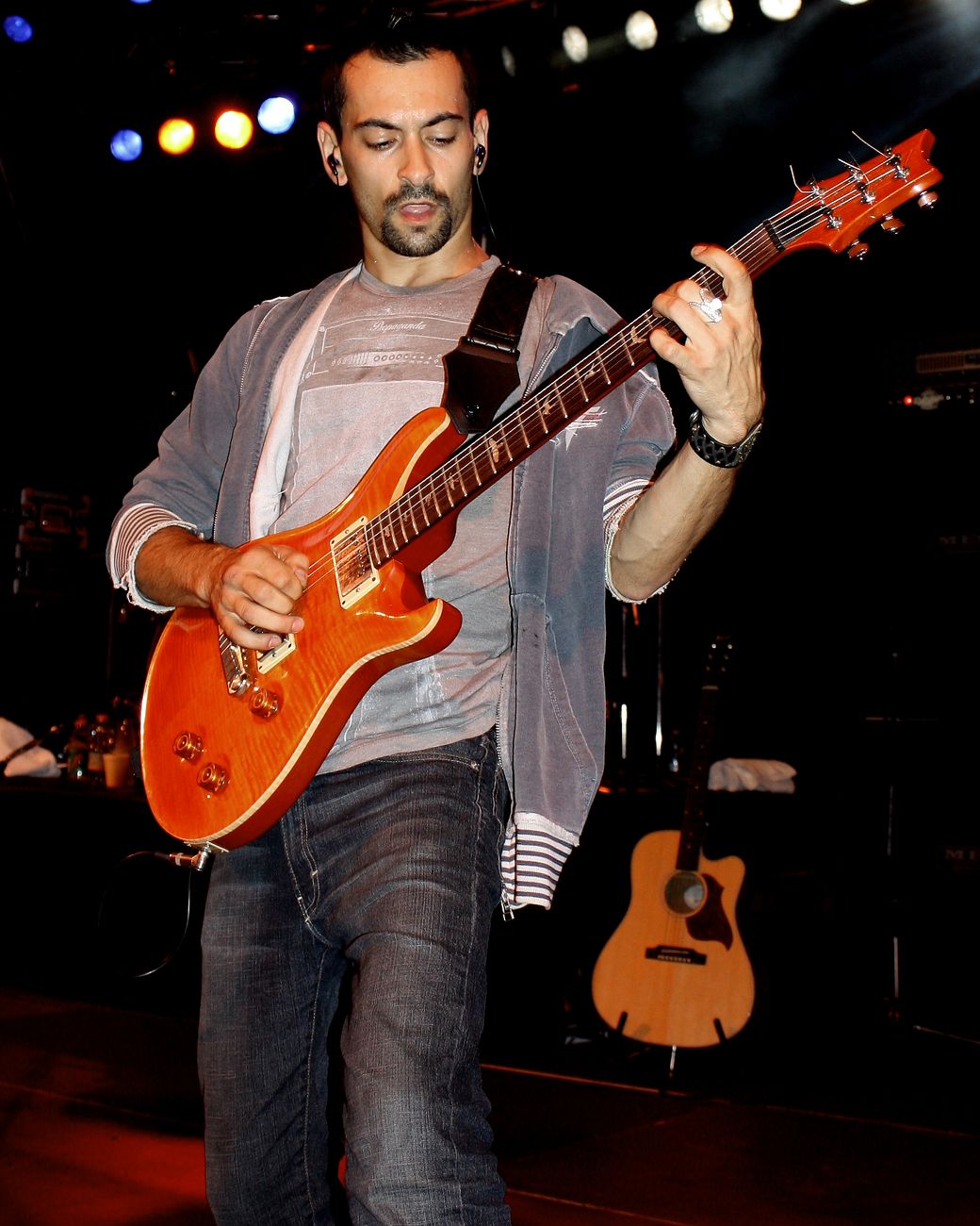 Alex Bodnar playing guitar on stage